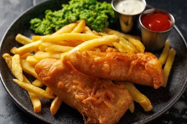 British Fish and chips with mashed peas, tartar and ketchup sauce